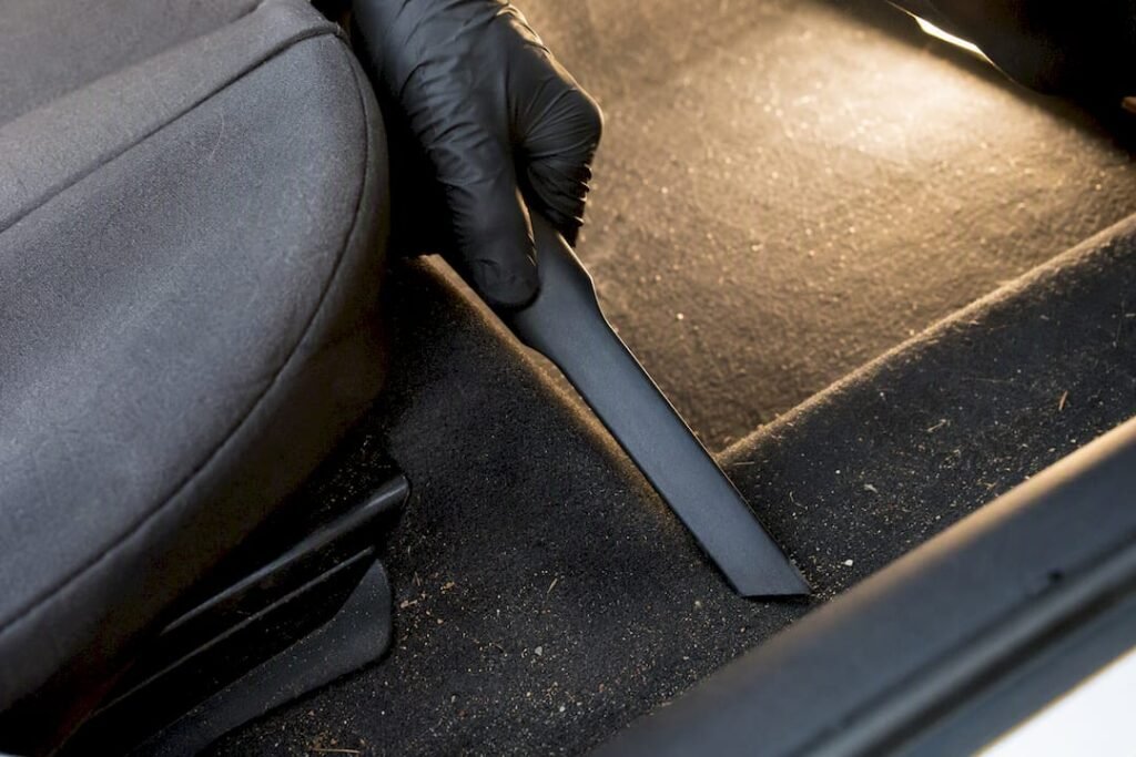 Vacuuming car carpet to find odour source