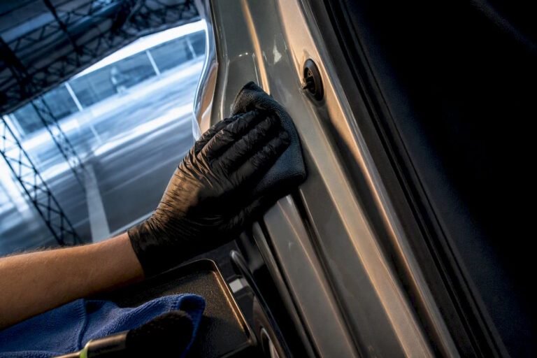 Hand cleaning an anonymous car door jamb