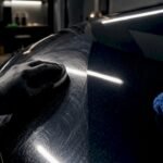 Detailer applying finish product to paintwork