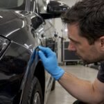 Detailer inspecting a PPF edge before coating