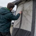 Technician checking mould on caravan awning
