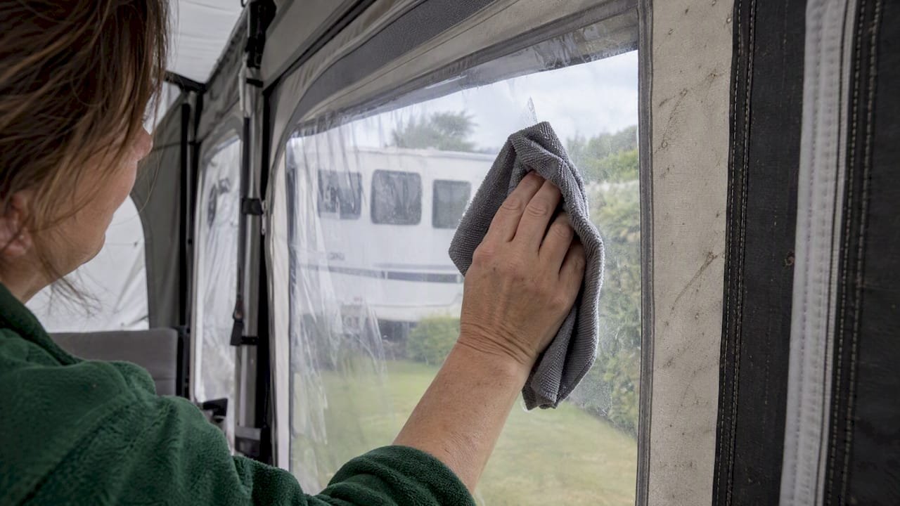 Soft cloth wiping a caravan awning window