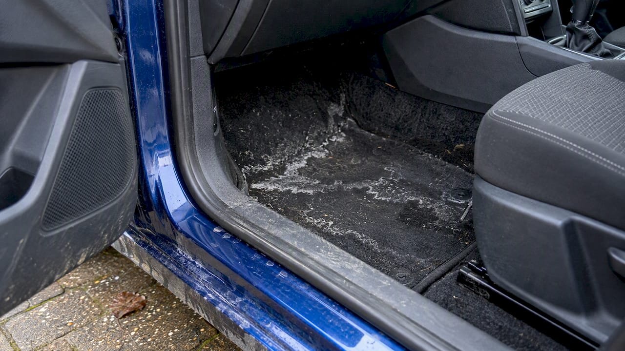 White salt tide marks on a car footwell