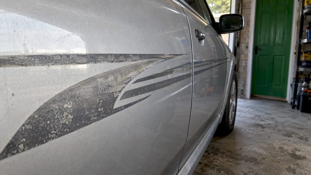 Faded vinyl decal on a silver car
